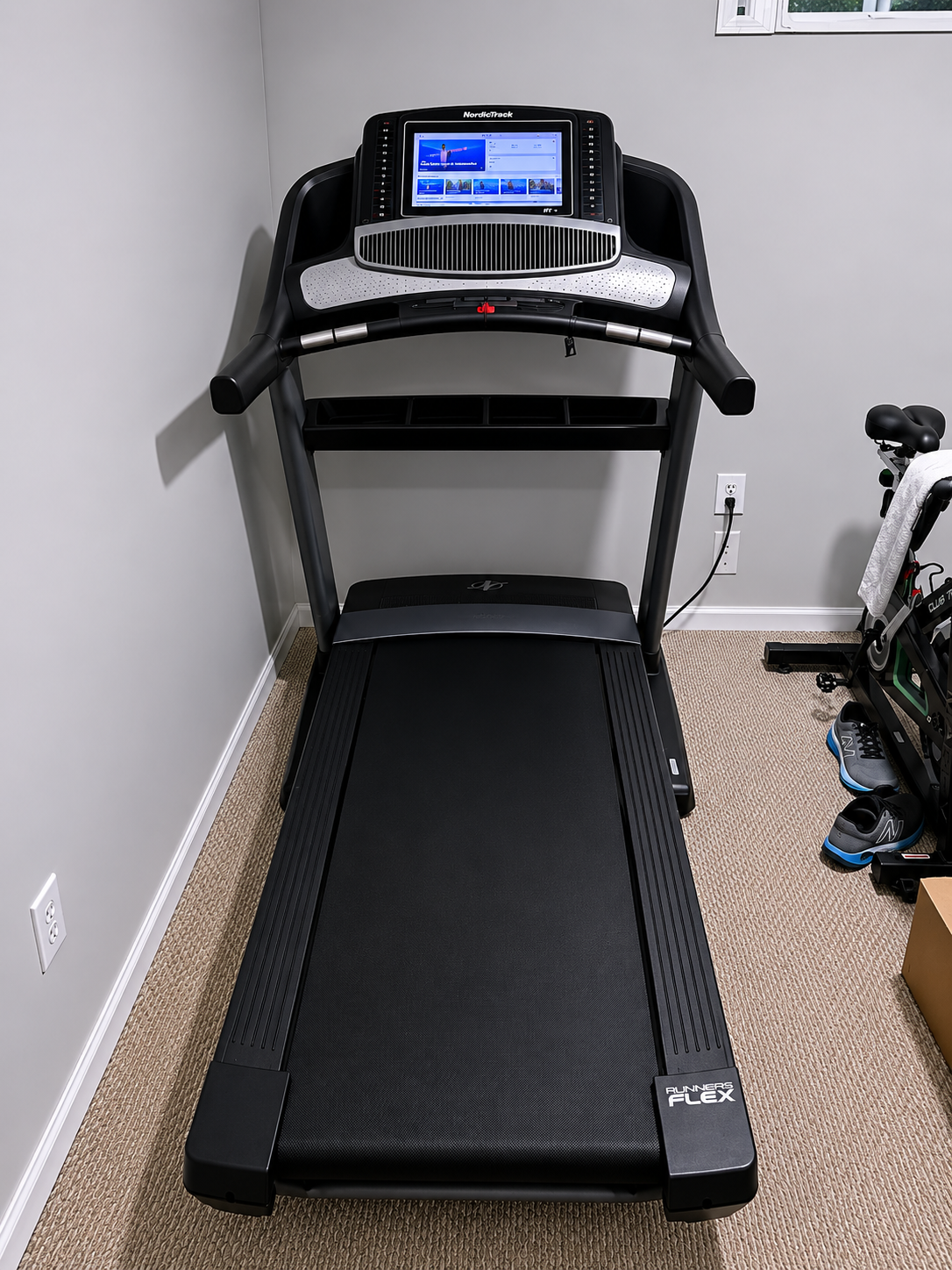Treadmill assembled in a home workout space.